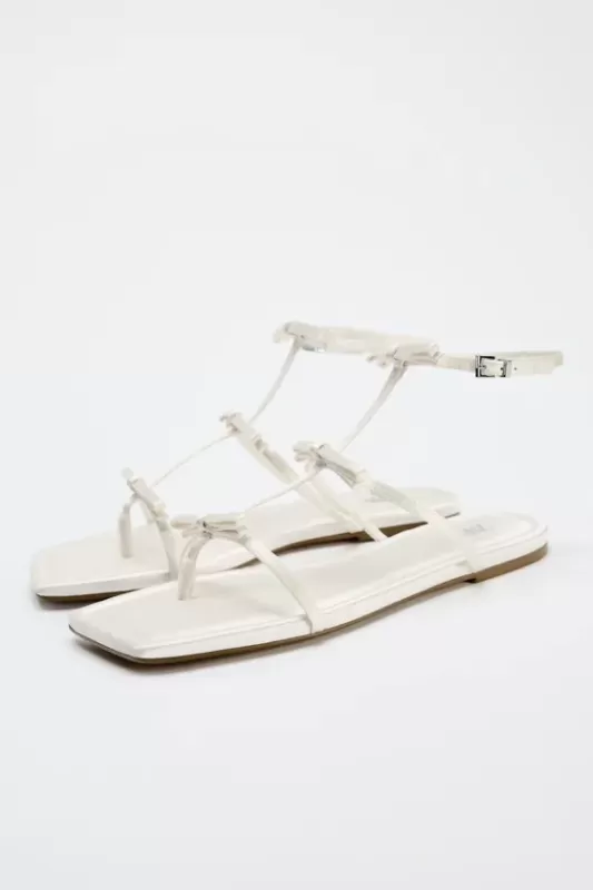 Flat-soled sandals with ties